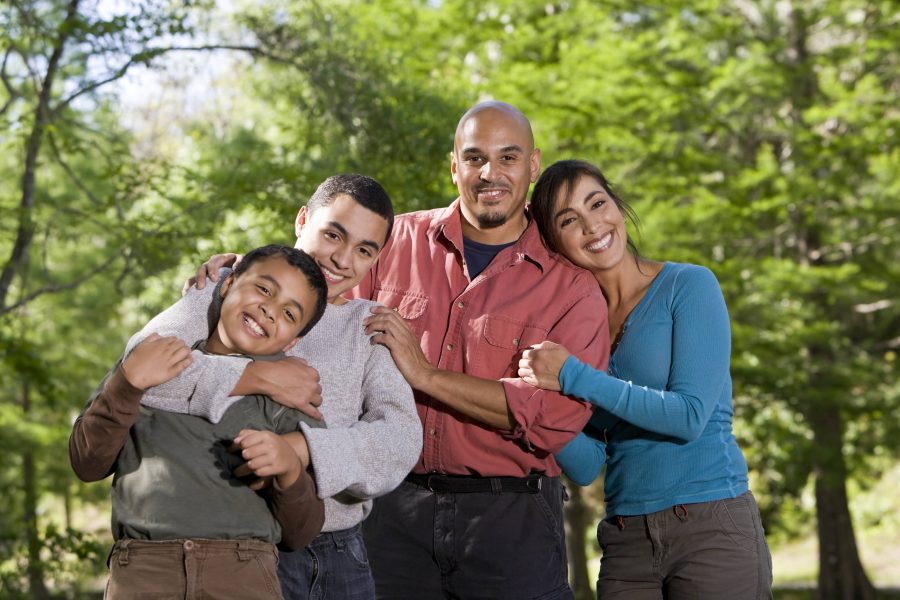 Portrait of Hispanic family with two boys outdoors