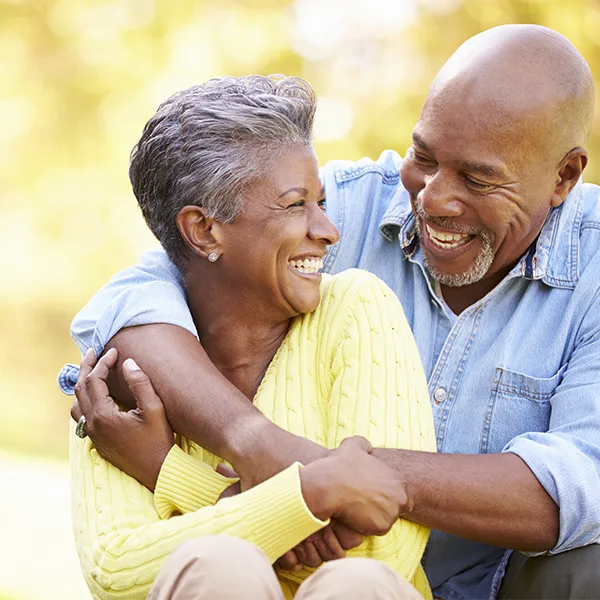 Happy couple outside laughing