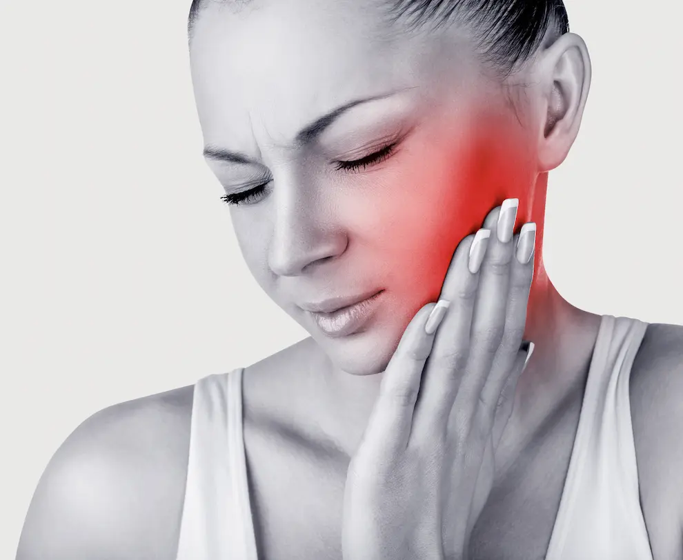 Woman trying to soothe her jaw pain