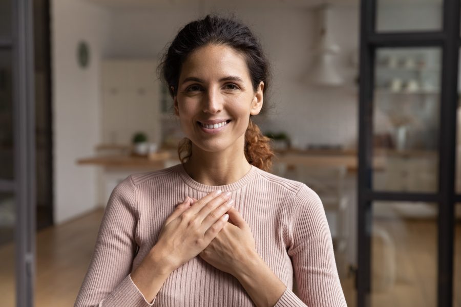 Head,Shot,Portrait,Smiling,Woman,Folded,Hands,On,Chest,,Feeling
