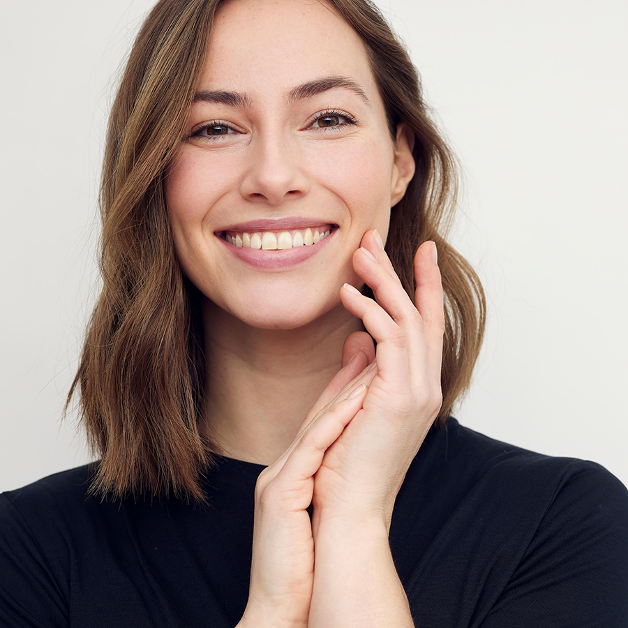 Portrait,Of,Young,Smiling,Woman,Looking,Happy,On,White,Background.